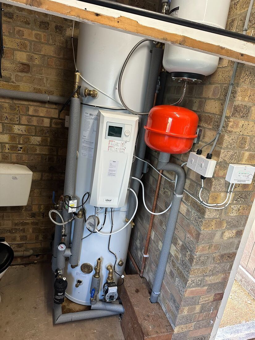 Unvented hot water cylinder with pipework and controls in a plant space